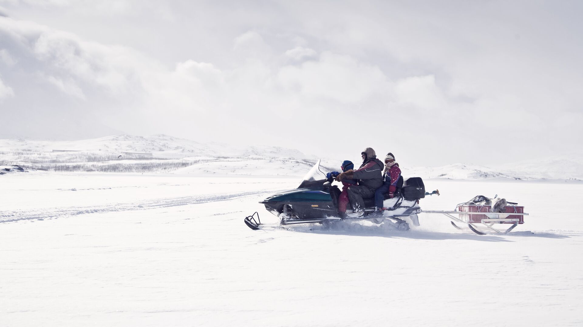 family on snowmobile