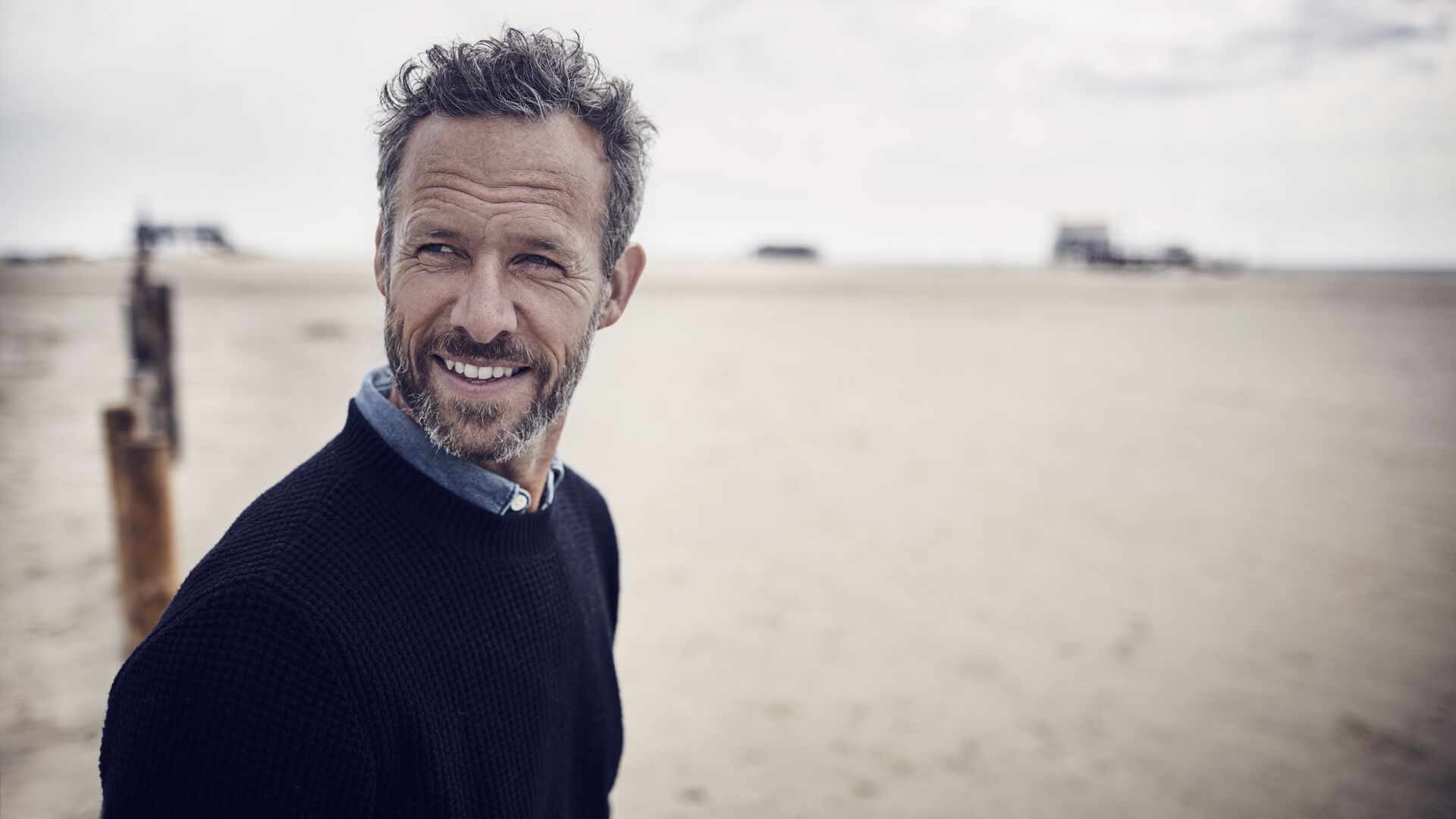 Smiling bearded man on the beach