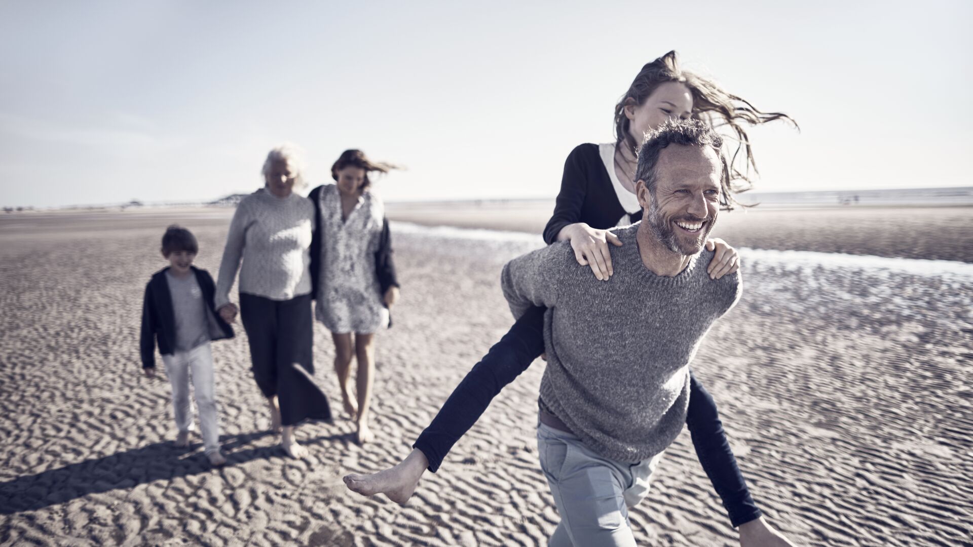 Three generations walking together at the beach