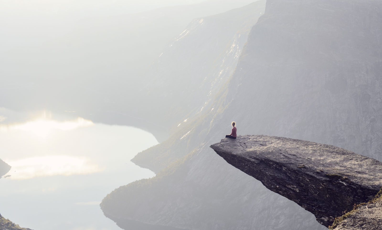 Woman-sitting-on-the-edge-of-a-cliff