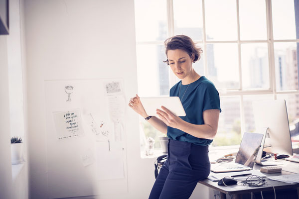 businesswoman-using-digital-tablet-in-office