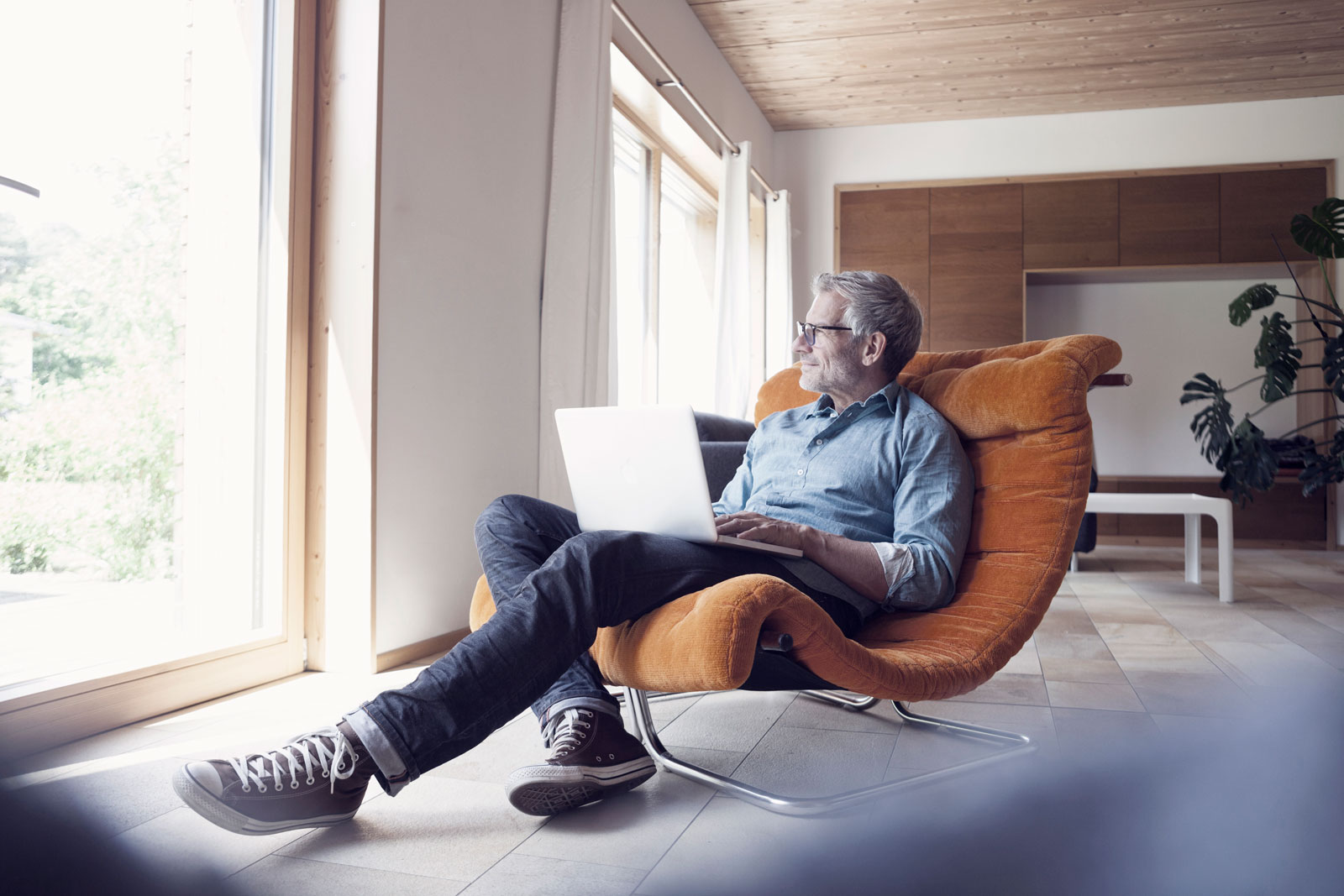 mature-man-using-laptop-in-armchair-reversed