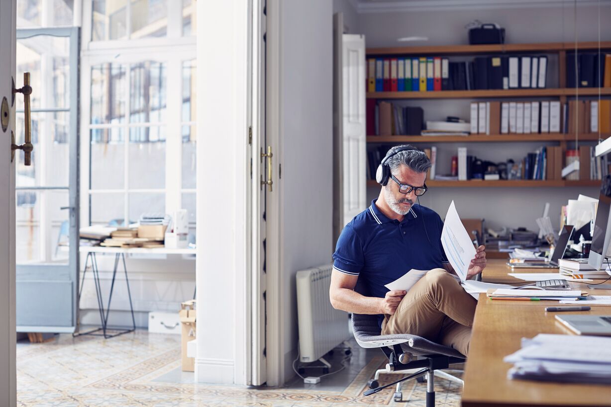 businessman-examining-documents-at-desk