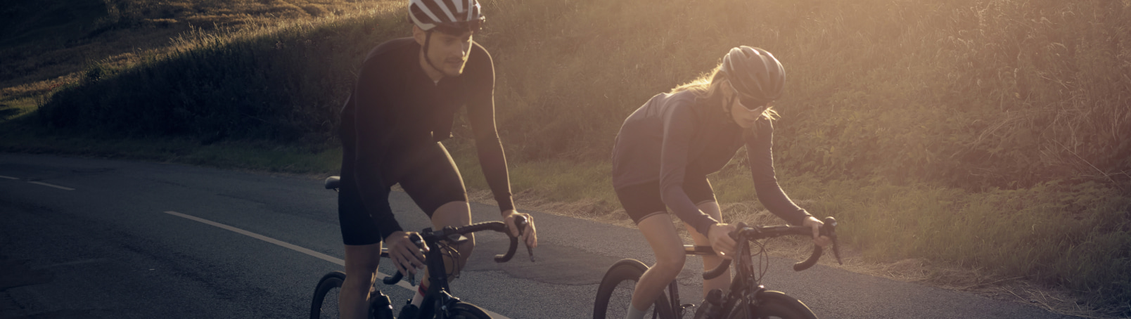 Two cyclists out cycling on a country road