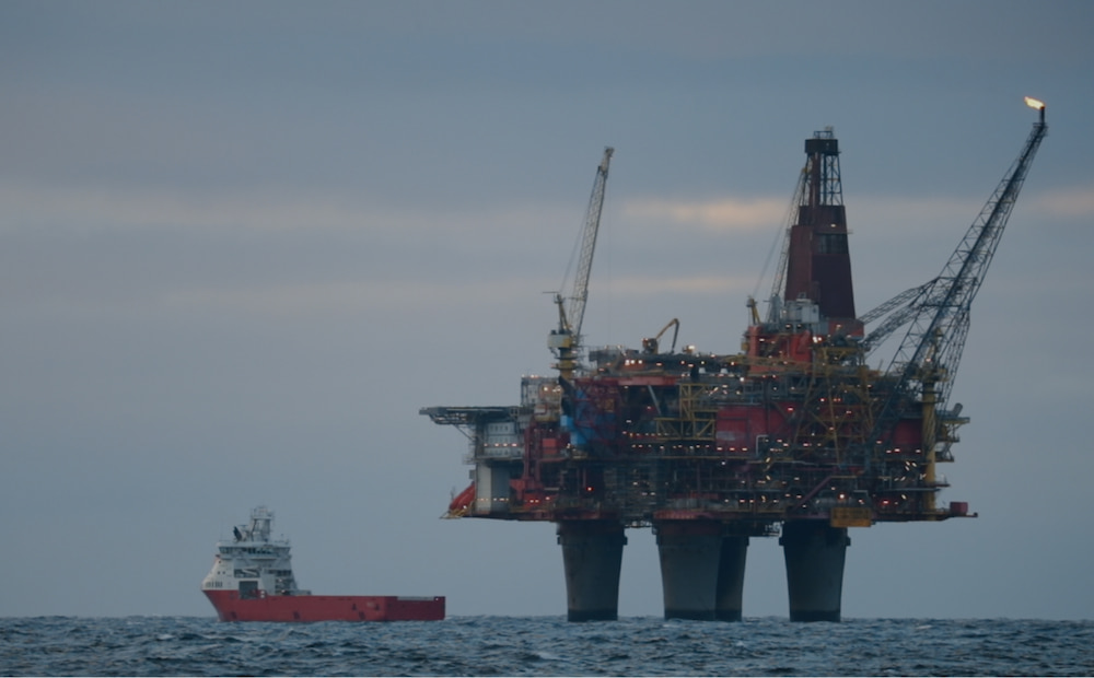 An oil rig in the middle of the ocean.