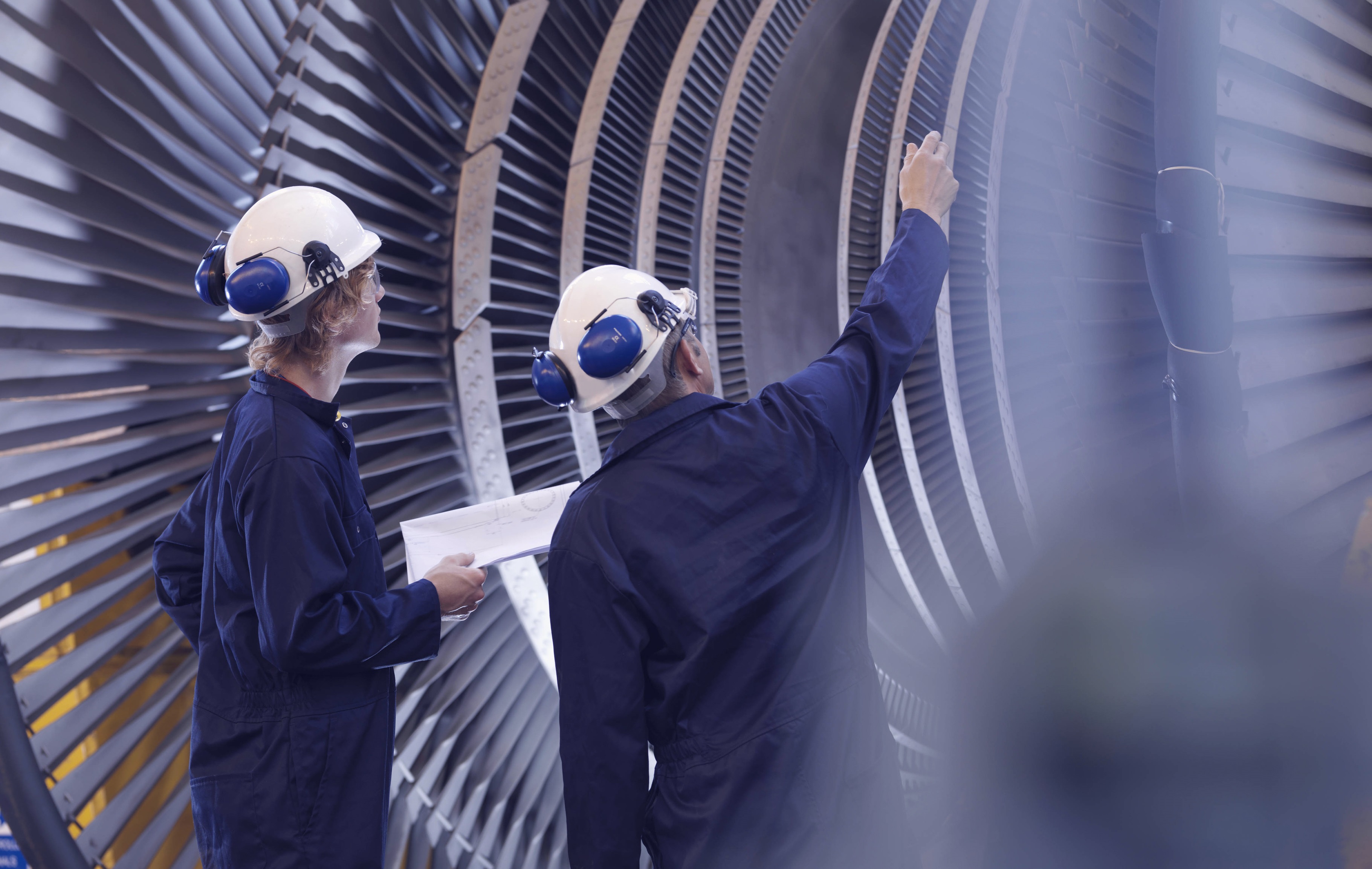 Engineers looking at turbine
