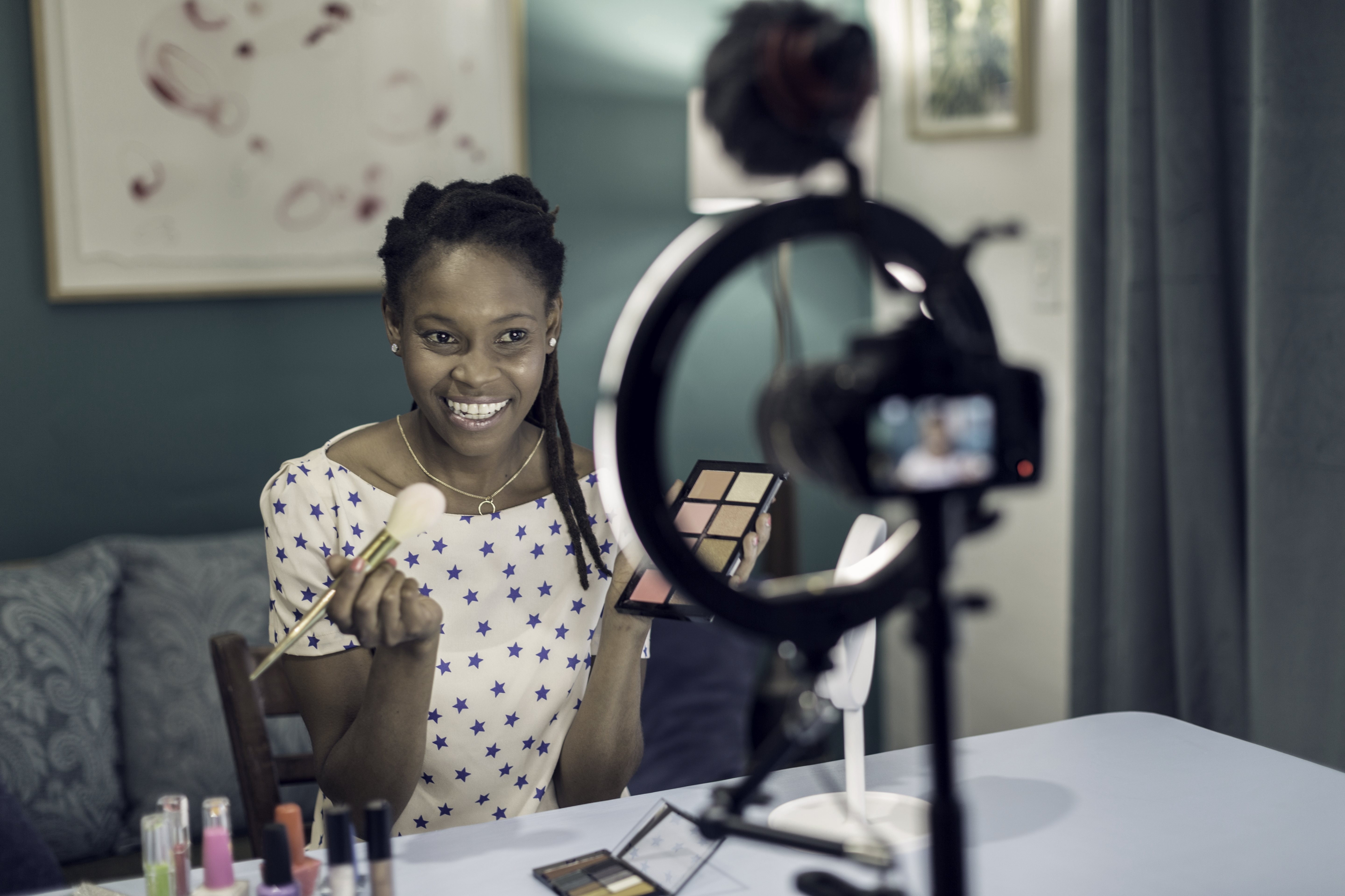 woman filming while doing makeup