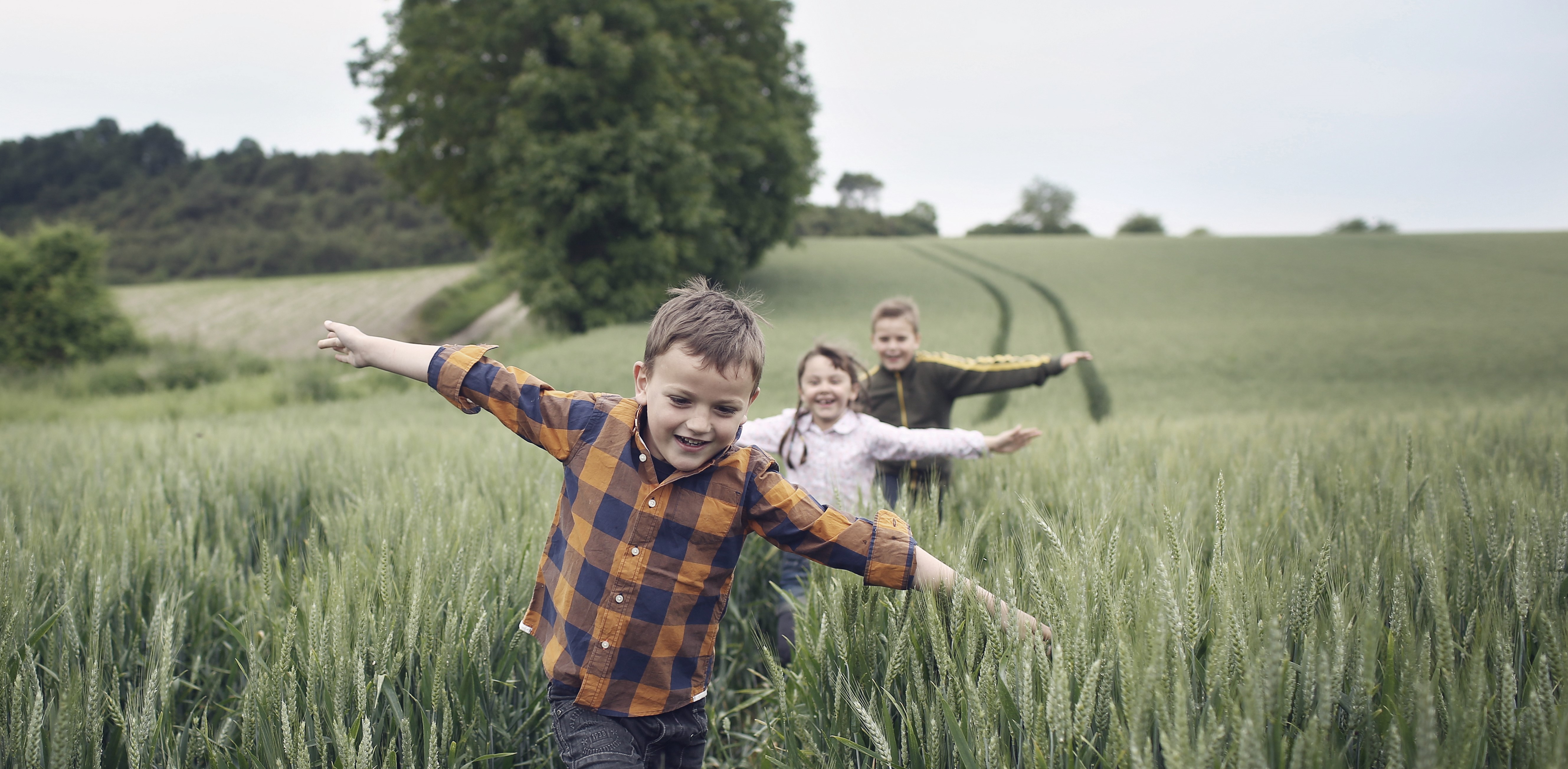 3-children-running-in-a-field