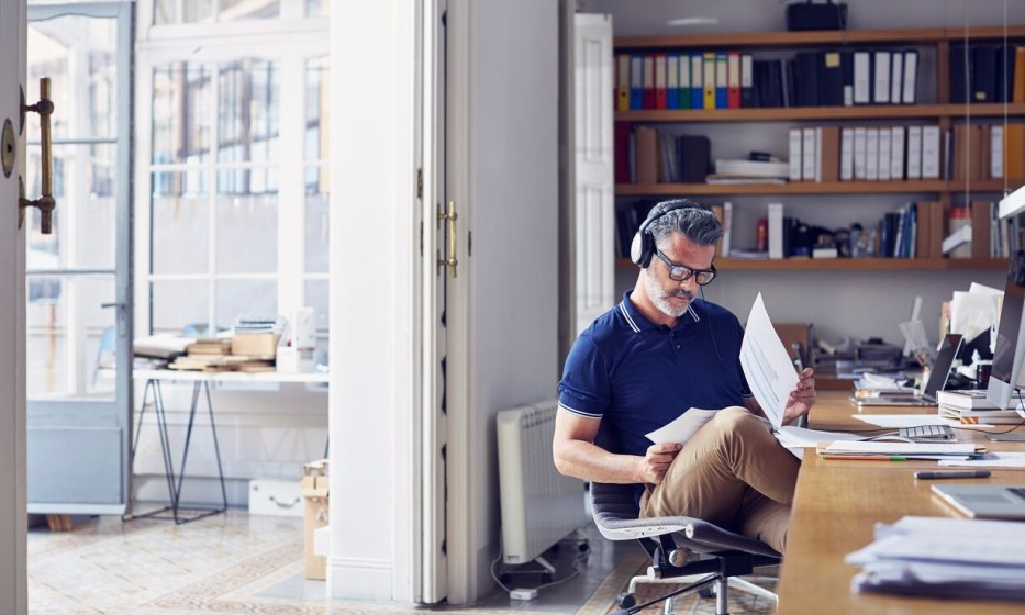 businessman-examining-documents-at-desk