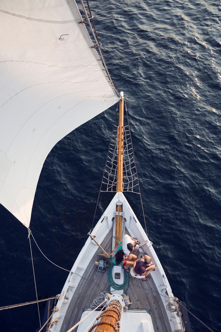 friends-on-bow-of-large-sailboat