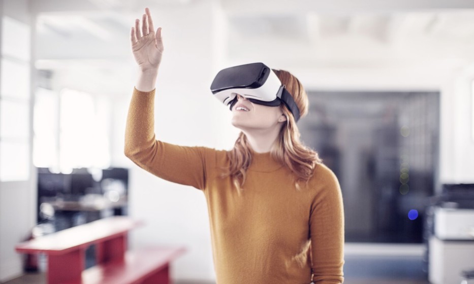 curious-businesswoman-using-vr-goggles