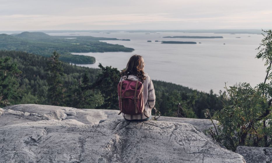 Woman looking at lake in Finland