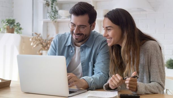 Couple sitting in front of laptop