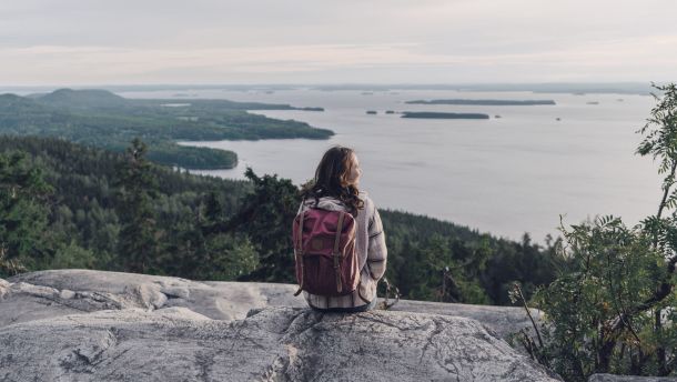 Woman looking at lake in Finland