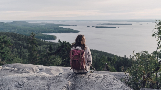Woman looking at lake in Finland