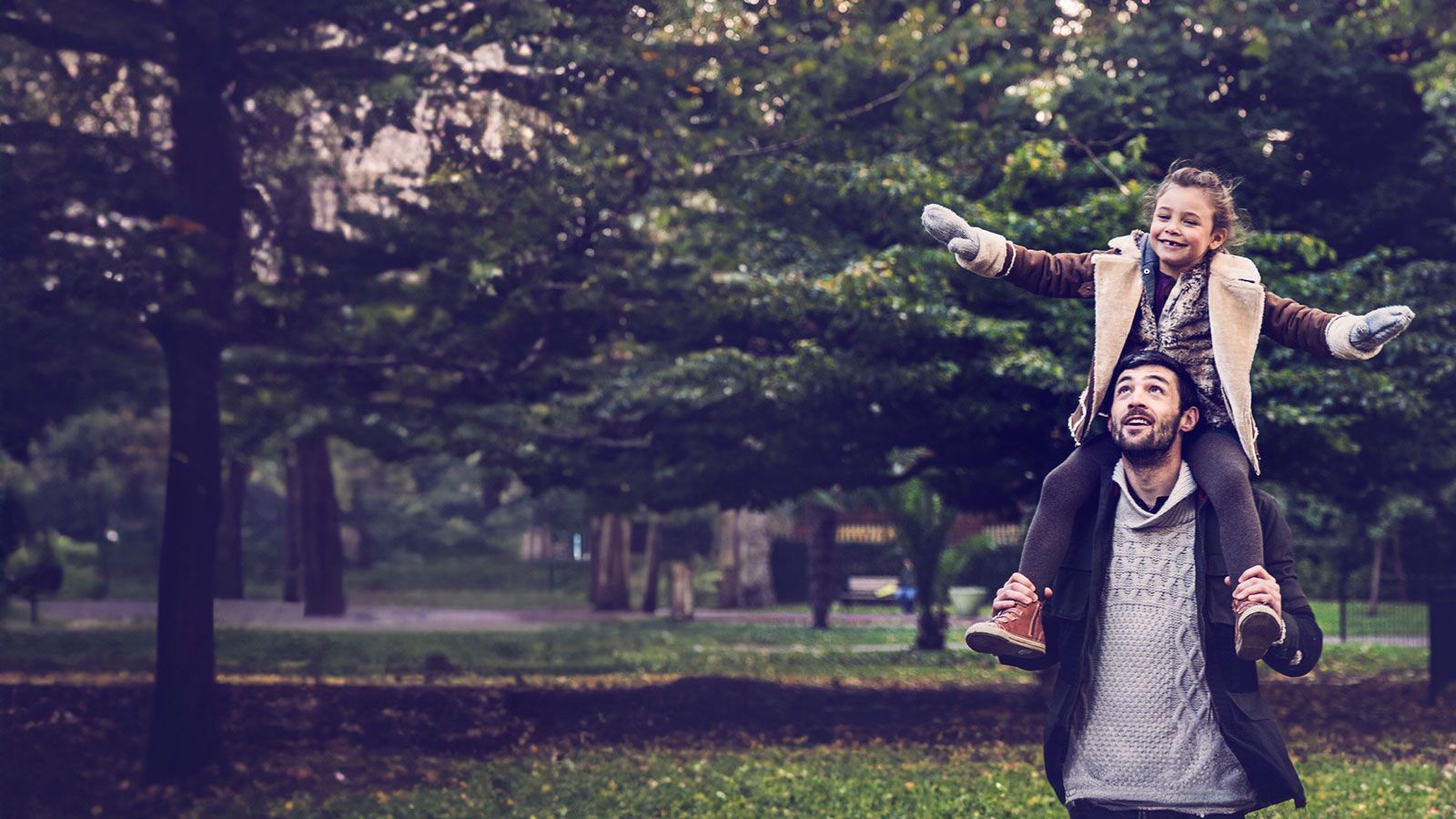 Father and daughter walking in the park