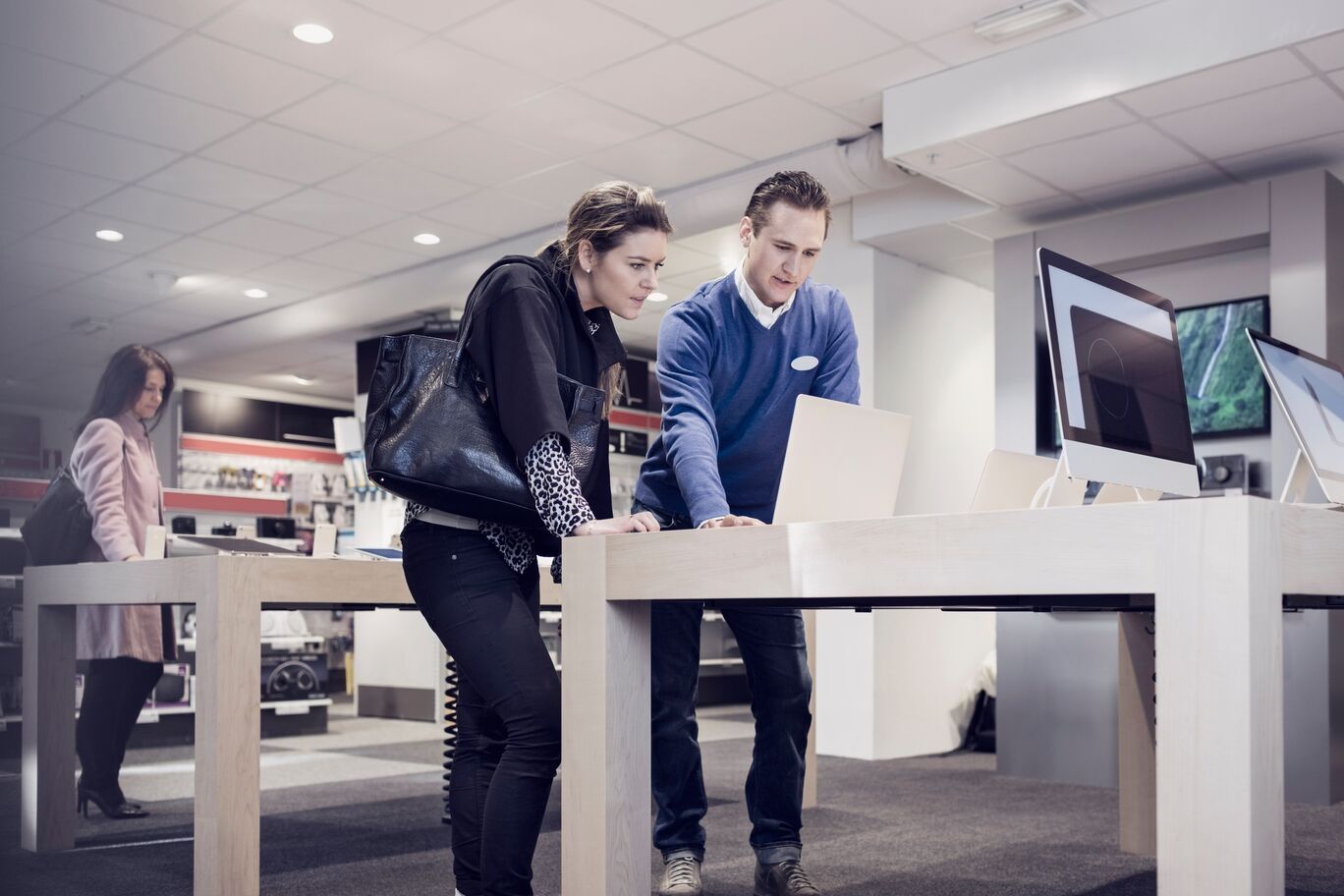 Female and male buying laptop