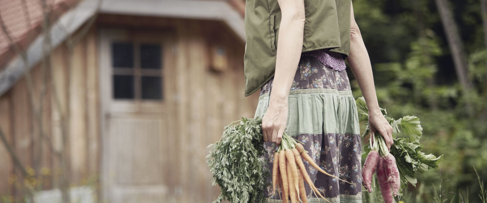 Woman carrying vegetables in garden