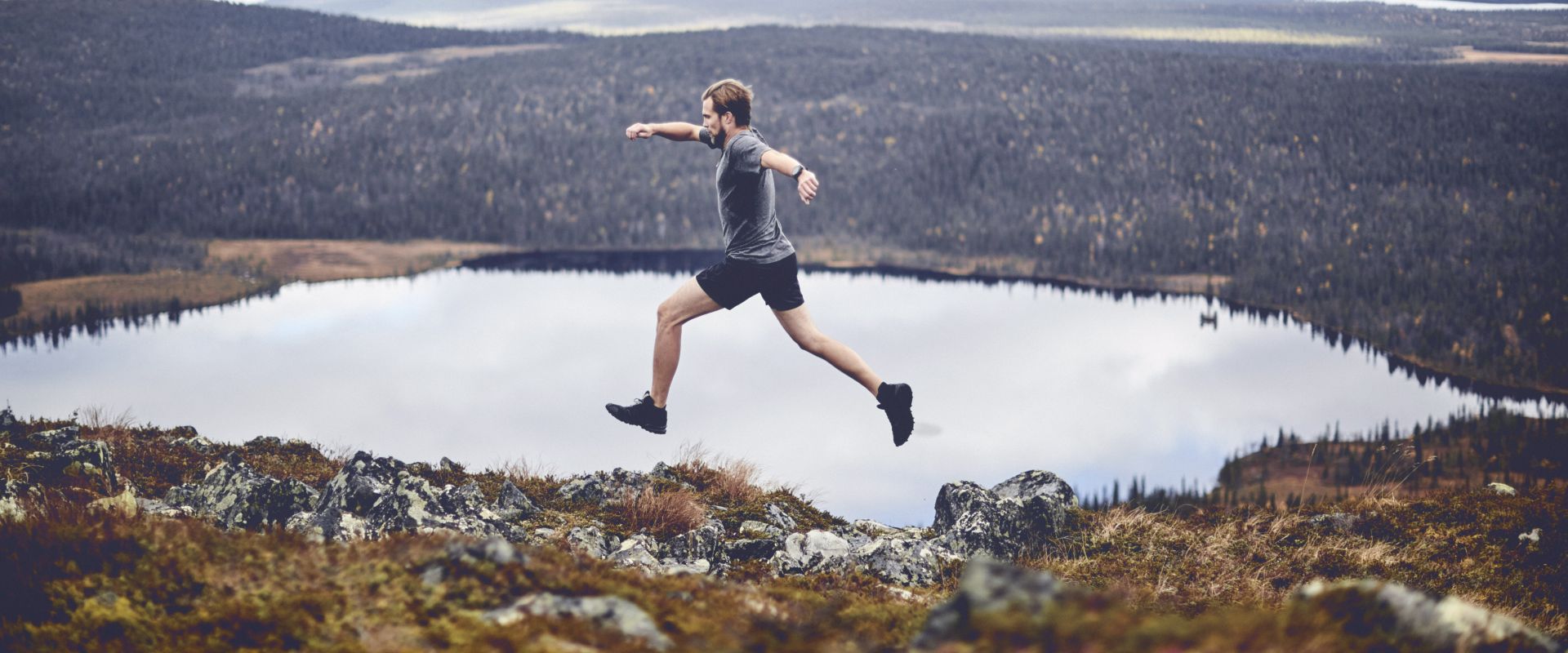 man-sprinting-on-rocky-cliff-top.jpg