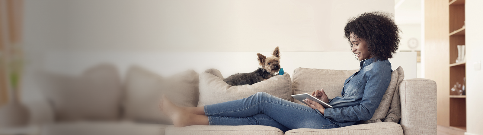 Woman lying on the couch with a tablet